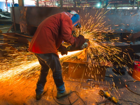 Welder uses a Grinding Machine to Grind Back Gouge the Back Welded on the Test Steel Plate  Before Back Welded for Welding Qualified Testing (WQT).の写真素材