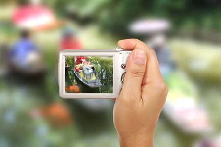 Hand and camera take Thai floating market photography outdoorの写真素材