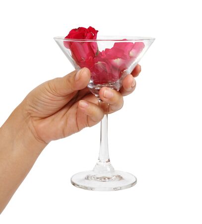 Closeup image of hand holding red rose in martini glass の写真素材