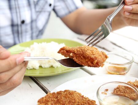 Closeup image of a man eating Thai food fried shrimp cakeの写真素材