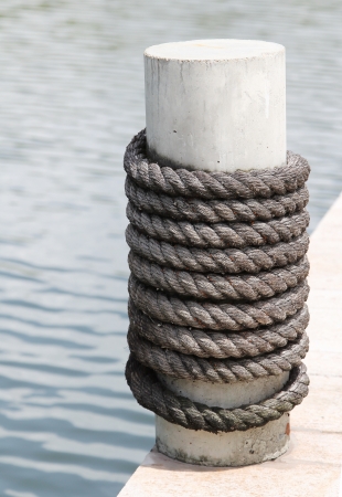 Closeup image of gray rope wrapped around a poleの写真素材