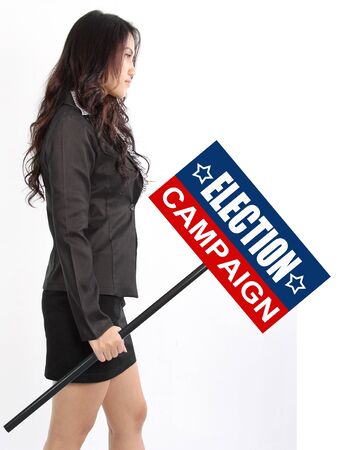 business woman holding election sign campaign calling people goto voteの写真素材