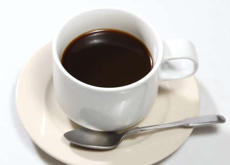 Closeup image of hot black coffee on white tableの写真素材