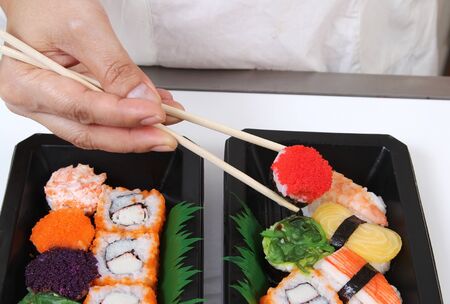 Closeup image of hand and chopstick prepare sushi japanese foodの写真素材