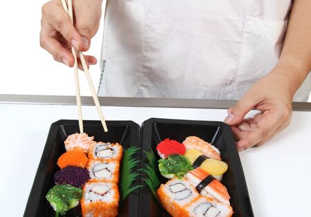 Closeup image of hand and chopstick prepare sushi japanese foodの写真素材