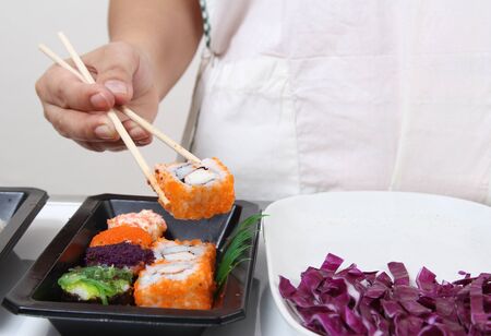 Closeup image of hand and chopstick prepare sushi japanese foodの写真素材
