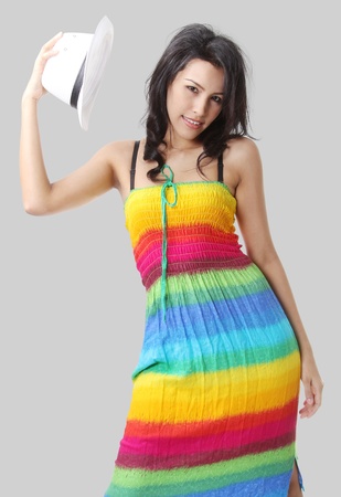 Image of beautiful asian woman in summer dress and white hat の写真素材