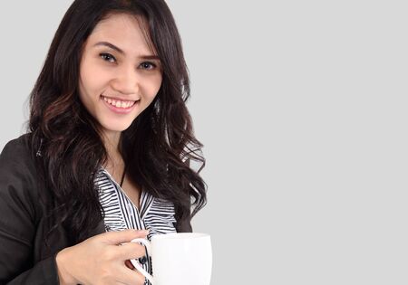 Image of asian business woman drinking coffee on white backgroundの写真素材