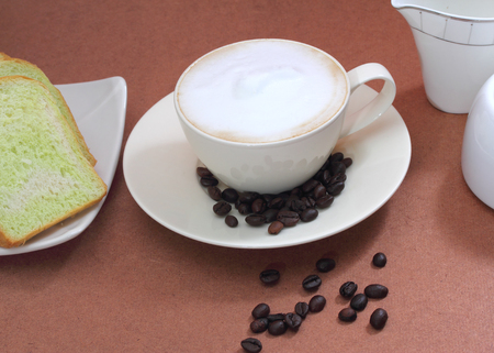 close up image of hot coffee and bread on table in coffee shopの写真素材