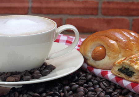 close up image of hot coffee with pie and bread on table in the morningの写真素材