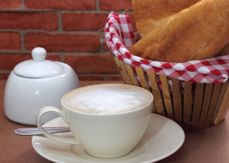 close up image of hot coffee and bread on table in coffee shopの写真素材