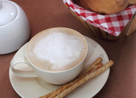 close up image of hot coffee and bread on table in coffee shopの写真素材
