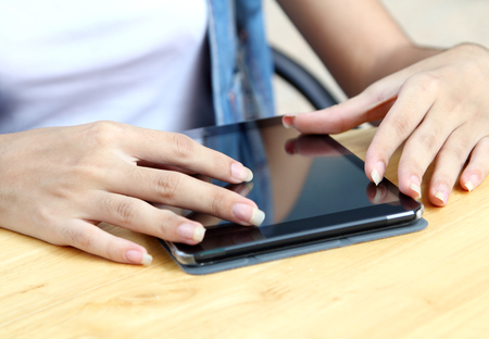 asian woman working touch her tablet and search information at coffee shopの写真素材