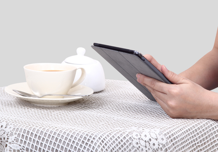 Closeup images of asian woman touch her tablet and hot coffee の写真素材