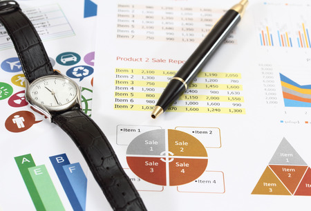 image of graphics and finance report for business with pen and watchの写真素材