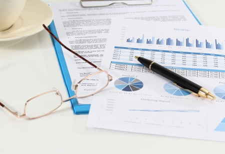image of graphics and finance report for business with pen and glassesの写真素材