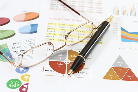 image of graphics and finance report for business with pen and glassesの写真素材