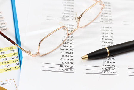 image of graphics and finance report for business with pen and glassesの写真素材