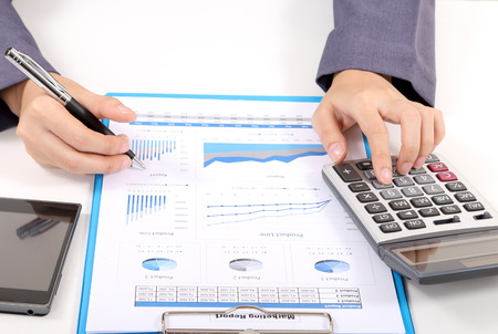 closeup image of business woman working on white desk at her officeの写真素材
