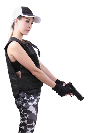 asian woman wearing bulletproof vest and holding a gun on her hand の写真素材