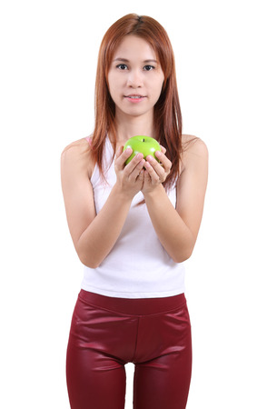 image of portrait young woman with an apple on white backgroundの写真素材