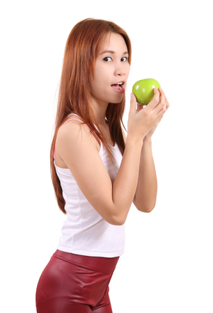 image of portrait young woman with an apple on white backgroundの写真素材