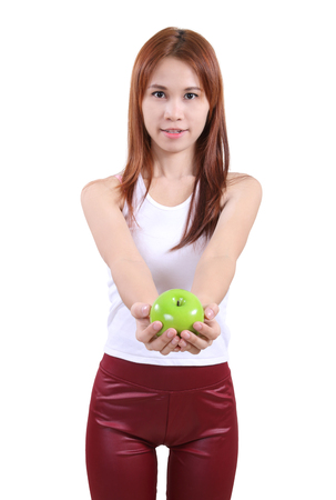 image of portrait young woman with an apple on white backgroundの写真素材