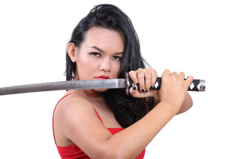 asian woman in red and black cloth holding samurai sword の写真素材