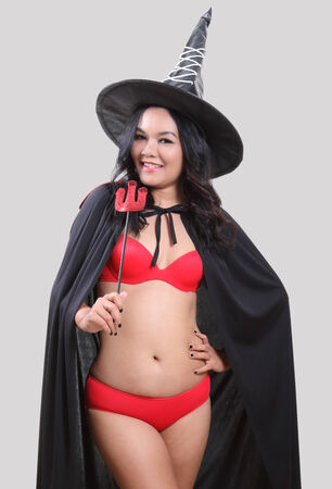 Image of portrait asian woman in red bikini and black hat on halloweenの写真素材