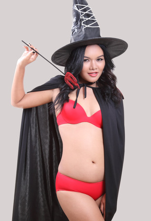 Image of portrait asian woman in red bikini and black hat on halloweenの写真素材