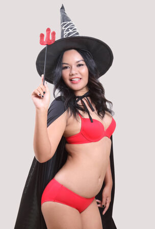 Image of portrait asian woman in red bikini and black hat on halloweenの写真素材