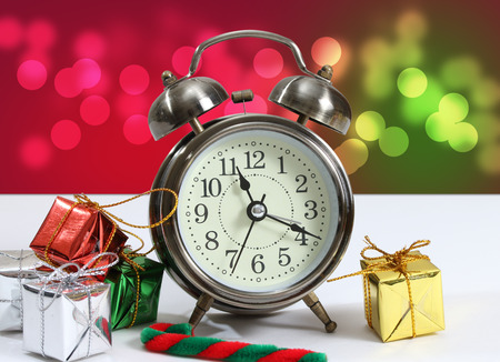 closeup image of little gift box and clock with bokeh backgroundの写真素材