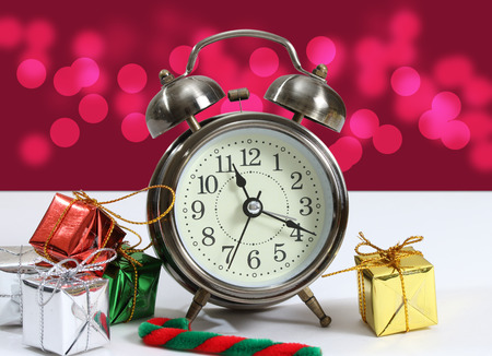 closeup image of little gift box and clock with bokeh backgroundの写真素材