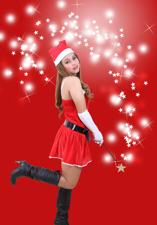 asian woman wearing santa claus clothes and red hat for christmas seasonの写真素材