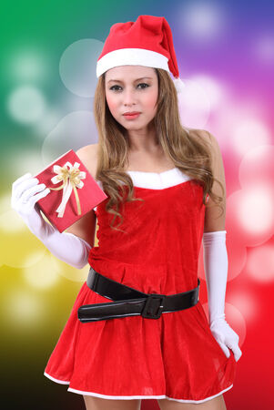 asian woman wearing santa claus clothes and red hat for christmas seasonの写真素材