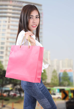 beautiful asian woman holding shopping bag on her handの写真素材