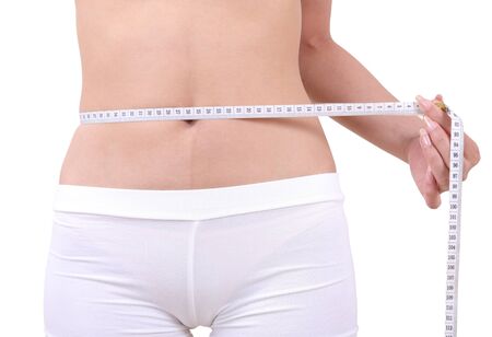 asian woman with measuring tape on her shape on white backgroundの写真素材