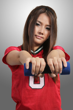 young asian woman in fitness clothes and dumbbellの写真素材