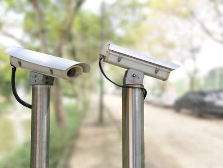 closeup image of CCTV security camera outdoor with blurred backgroundの写真素材