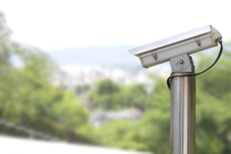 closeup image of CCTV security camera outdoor with blurred backgroundの写真素材