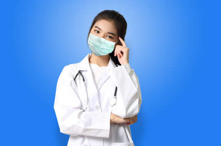 asian woman doctor in white uniform with maskの写真素材