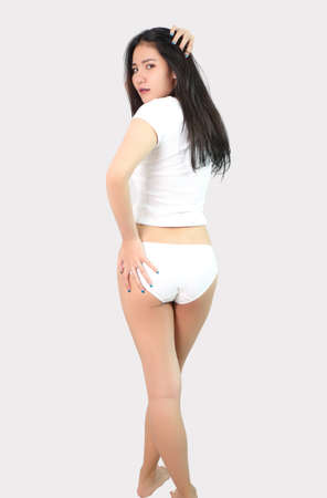 A woman in white shirt and underwear on grayの写真素材