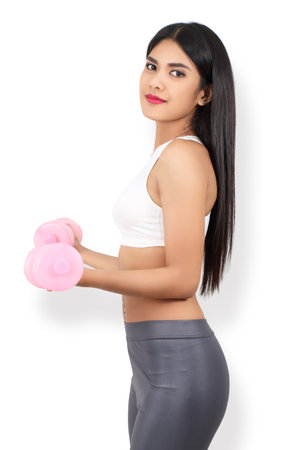 young asian woman in sport wear workout with dumbbell and white  backgroundの写真素材