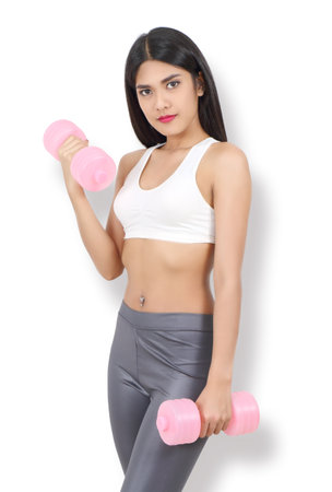 young asian woman in sport wear workout with dumbbell and white  backgroundの写真素材
