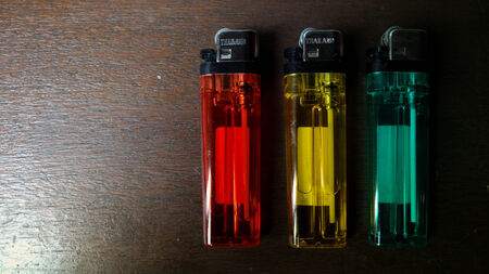 Thailand Lighters on table, Red Yellow Greenの写真素材