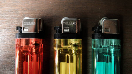 Thailand Lighters on table, Red Yellow Greenの写真素材