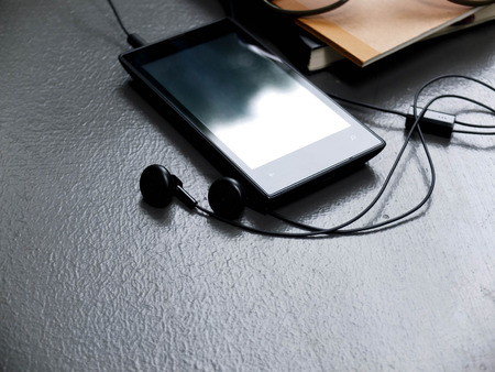 mobile music player on cement floorの写真素材