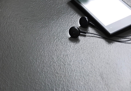 mobile music player on cement floorの写真素材