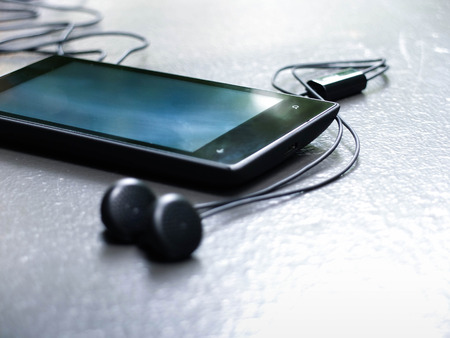 mobile music player on cement floorの写真素材