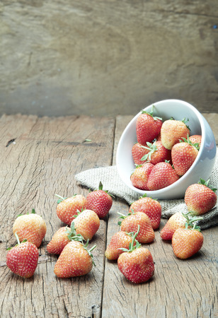 Fresh strawberries on old wooden backgroundの写真素材